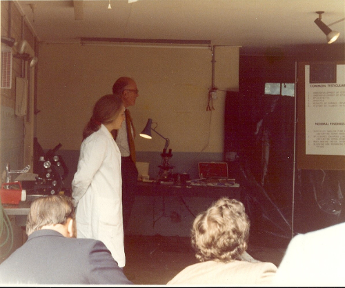1977 Wallace Deas assisted by technician, Anne Williamson, explains the laboratory techniques used in fertility testing of farm animals